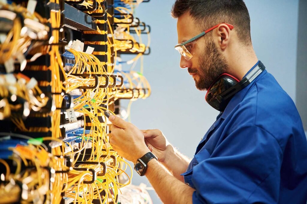 side view of a young man working with internet equipment
